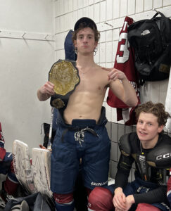 hockey player posing with team award